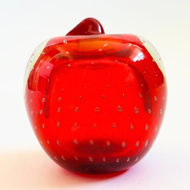 A vintage art glass apple paperweight. Vibrant red color to the glass. Beautiful controlled bubbles to the center of the...