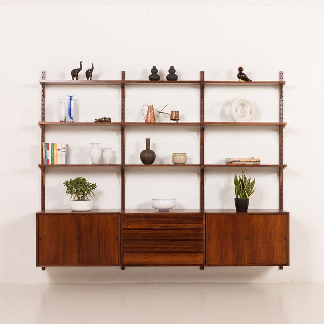 Extremely elegant rosewood wall unit designed by poul cadovius for cado in the 1960s. The simplicity is paired here with...