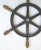 Circa 1940s cast iron boat steering wheel in black paint with wood handles, handles have brass screws on ends. No makers...
