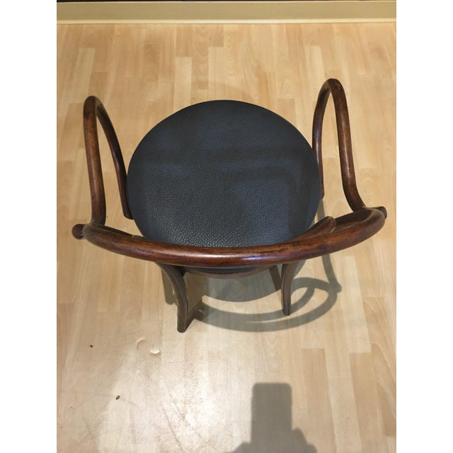 Set of 8 bentwood dining chairs with new pebbled off black vinyl upholstery. Some aging marks on arms and a repair on one...
