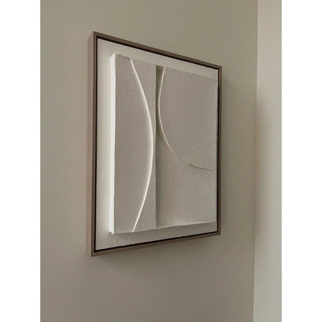 Minimalist plaster relief painting framed in a beige wood grain floater frame. Size: 18x24