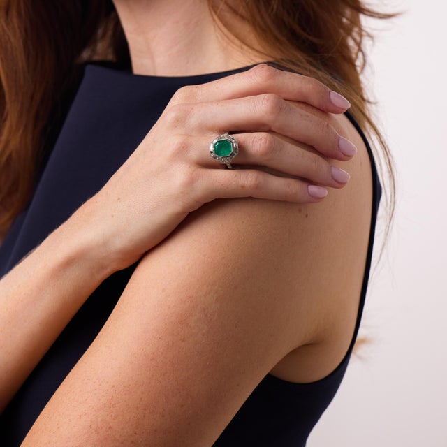 This beautiful Art Deco style emerald and diamond ring is a sophisticated vintage-inspired design from the 2000’s,...