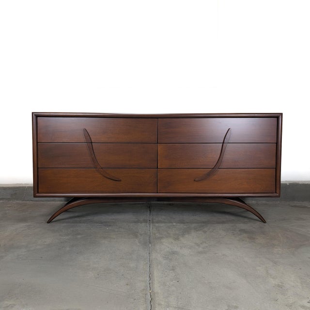This exceptional vintage mid-century modern dresser dates to the 1960s and showcases a refined blend of sculptural form...