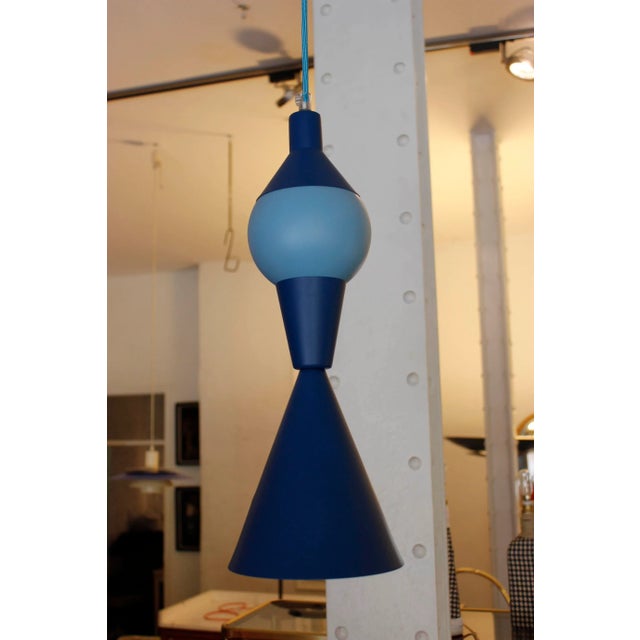 This geometric ceiling lamp is in various shades of blue with a matching cable. It was designed by Juanma Lizana. Up to...