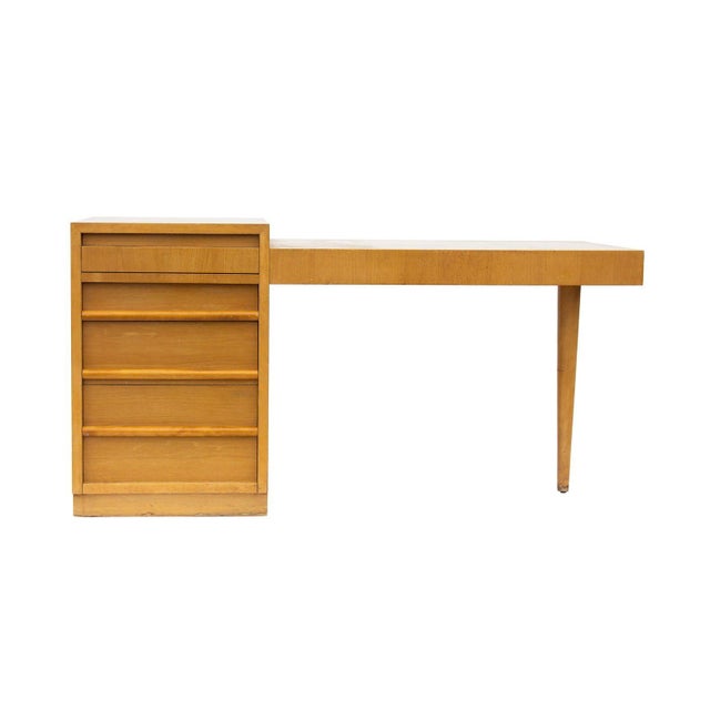 USA, 1957 Desk designed by T.H. Robsjohn-Gibbings for Widdicomb in Sorrel finish (walnut). Offers a bank of divided...