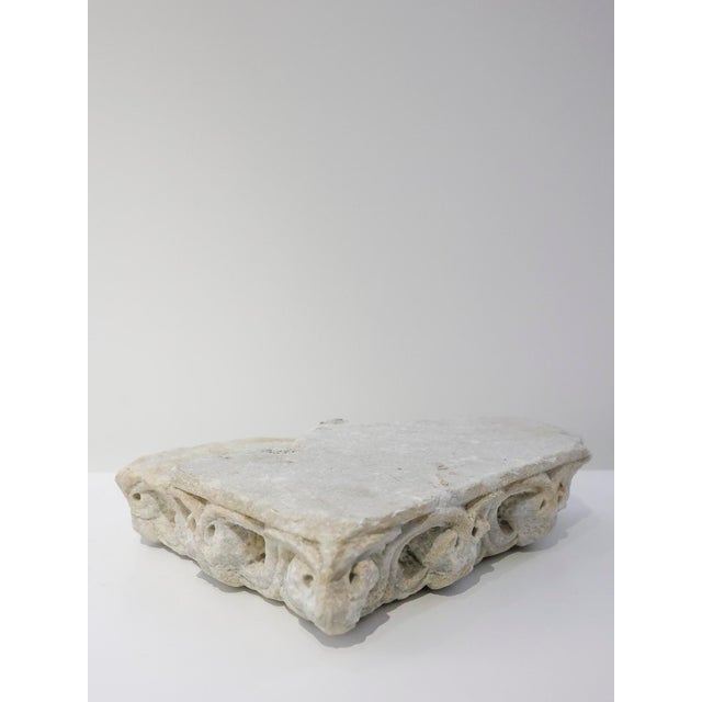 Fragment of a Romanesque marble cornice - 13th century. The fragment features a sculpted decoration with stylized plant...