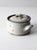 A vintage studio pottery bowl with a softly speckled glaze, blue-gray edging, and organic rust-toned firing marks. The...