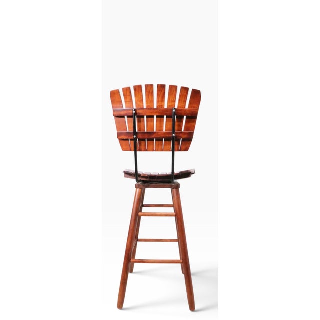 Pair of wood slat bar height swivel stools, designed by Arthur Umanoff. The stools are in excellent condition, having been...