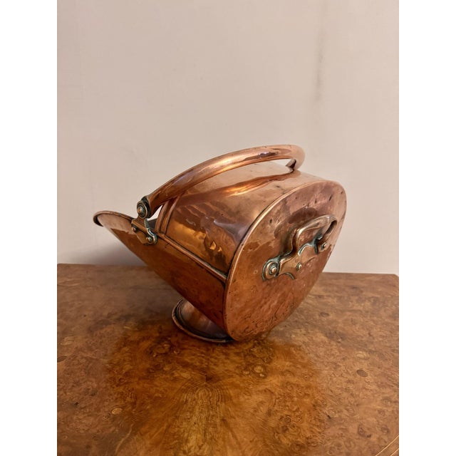 Antique George III copper helmet coal scuttle having a quality helmet coal scuttle with a swing handle, carrying handle a...