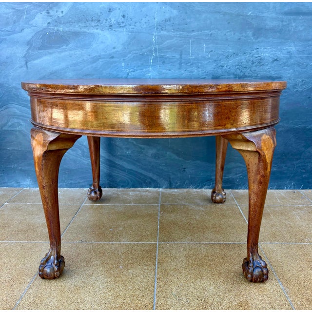Elegant Spanish round side table dating to the early 20th century. The table features a circular top above a shaped apron...