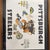 At the center, a cartoon Steelers player wearing #12, Terry Bradshaw's number and the game's MVP, bursts through a torn...