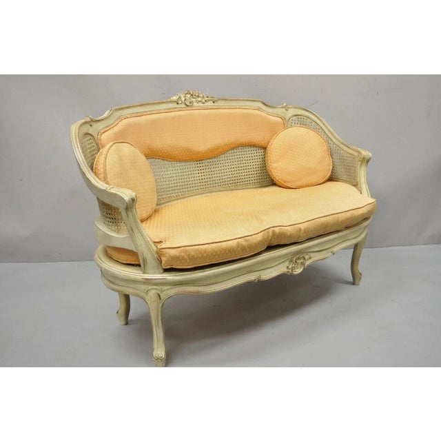 Vintage French Louis XV Victorian Style Small Cream Painted Settee Loveseat Sofa. Item features a cane back and seat,...