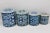 A charming set of four blue and white delft brand metal canisters. Perfect practical kitchen, office, or bathroom decor....