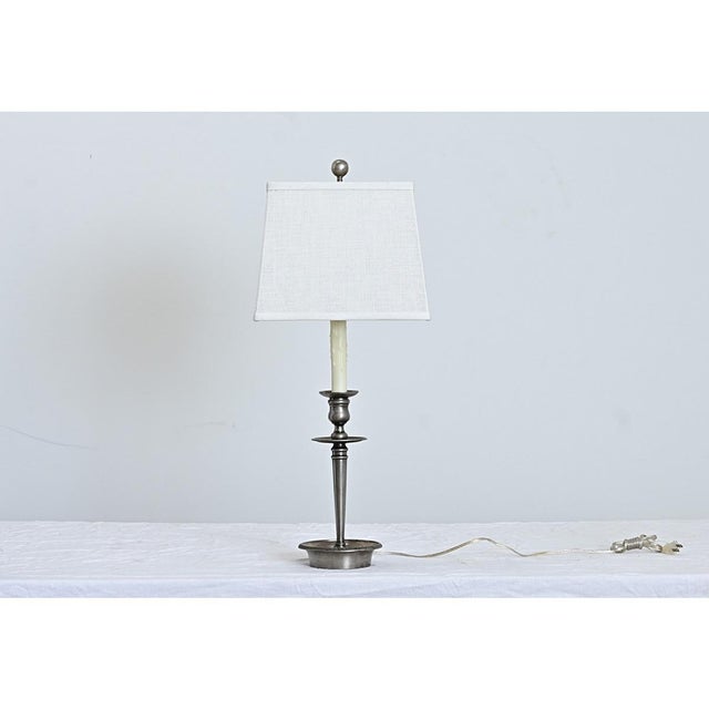 Polished in taste and patina, this vintage French pewter candlestick was converted to a small table lamp to illuminate a...