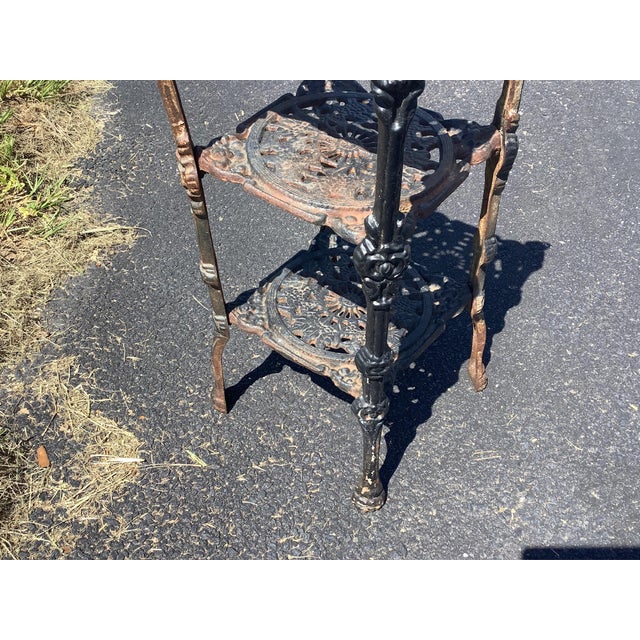 Solid heavy Iron 3 shelf plant stand. French victorian detailing right down to the feet. Sold in its current condition to...