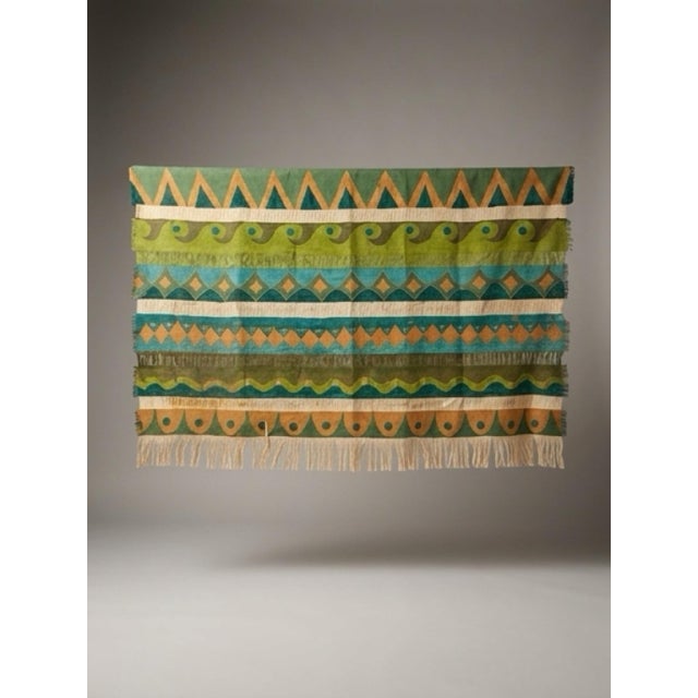 Large vintage 1970s bohemian textile wall hanging featuring bold geometric and tribal-inspired motifs in rich teal, olive,...