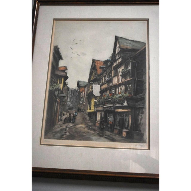 Very nice hand colored print by French artist Lucien Veder, or "Le Garf". This piece depicts a street scene in the French...