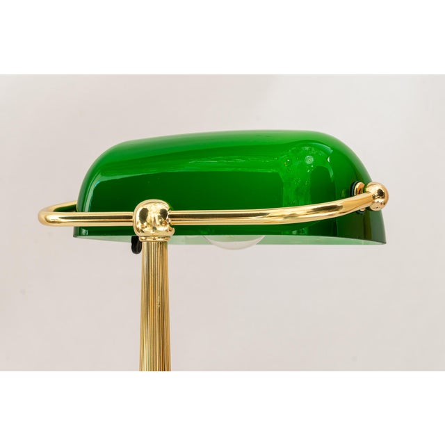 Art Deco banker lamp with green glass shade vienna around 1920s. Brass polished and stove enameled. European Plug (up to...