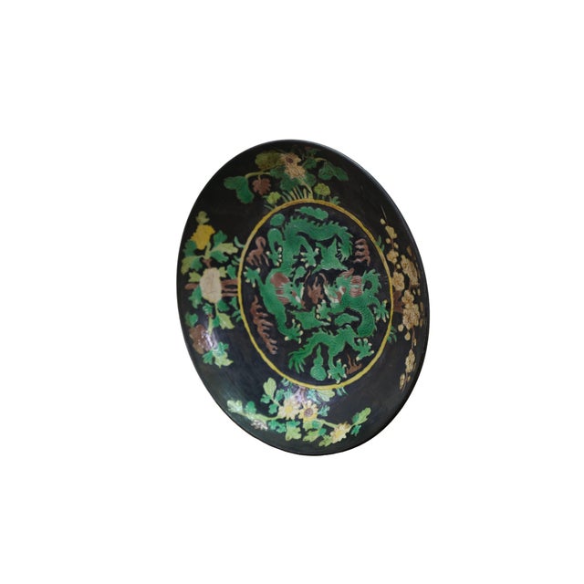 Antique Chinese famille noire porcelain plate / dish / bowl features a dramatic black ground accented by vibrant green...