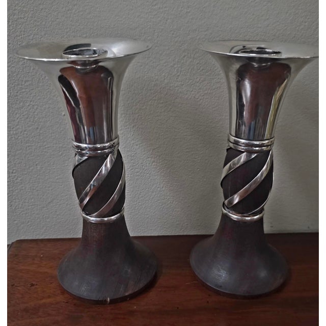 The product is a set of William Spratling Sterling Silver and Rosewood Candlesticks. These freestanding, round candle...