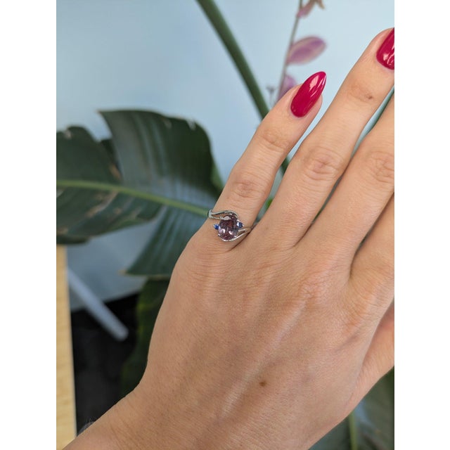 A pink-and-blue bi-color tourmaline glows at the center of this solid 14K white gold estate ring, accented by two small...