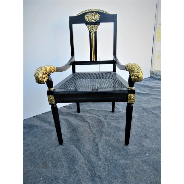 French Art Deco Open Arm Chair, Black Ebonized frame with gilt carved floral accents, caned seat