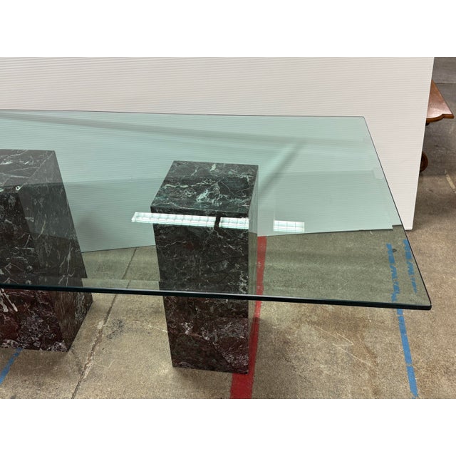 Plus Gallery presents a Pair of Faux Marble Bases + Glass Top Table. It is supported by two faux marble pedestal bases...
