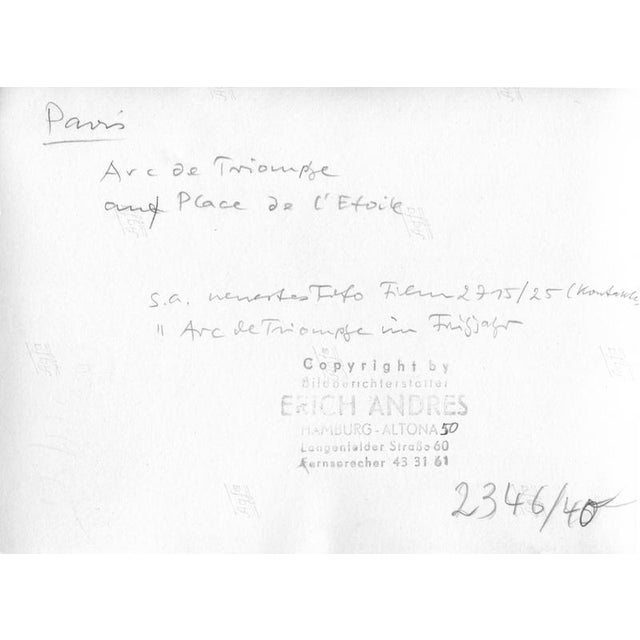 This is a black-and-white photograph of the Arc de Triomphe in Paris, France, taken in 1952. The image shows the...