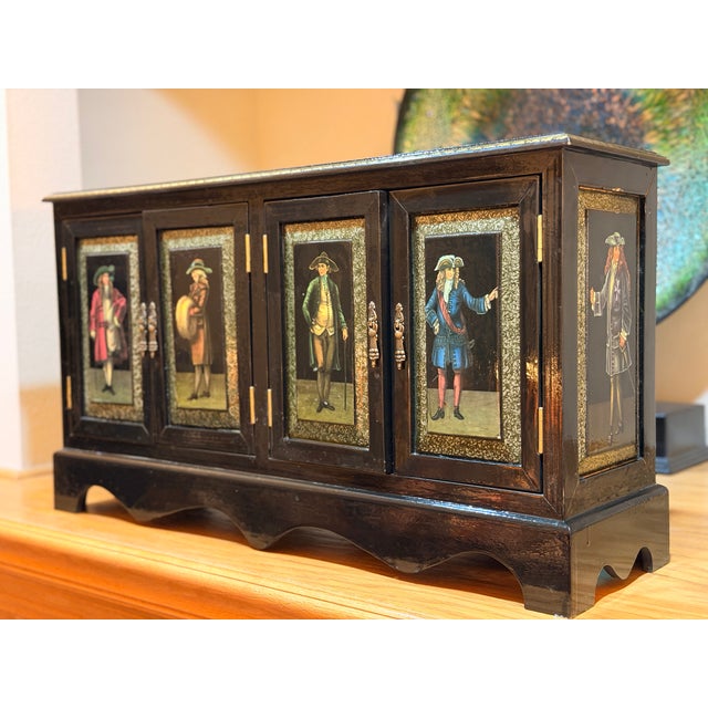 This unique black lacquer dry bar, dating from the 1950s, is a quite an interesting piece. The black lacquer background is...