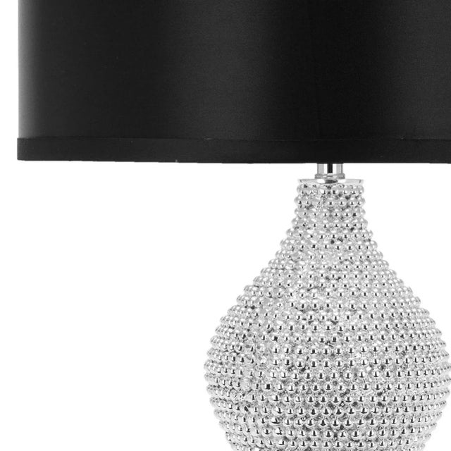 Let your room radiate in the shimmering glamour of the Bead Lamp. Crafted of polyresin with a double gourd body, the...