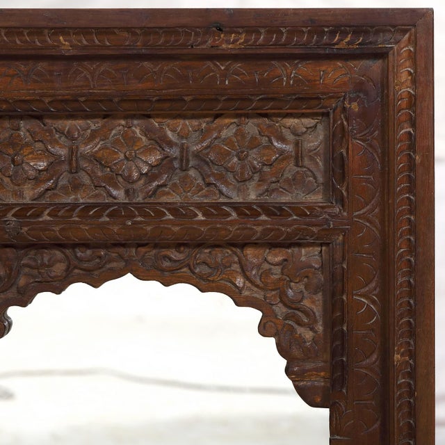 The crisply carved arch and frame was originally a Rajasthani window and would have held small shutters inside. In a rich...
