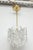 Elegant Ice glass chandelier by Kalmar. The brass armature supports twelve textured ice glass elements. The fixture has...