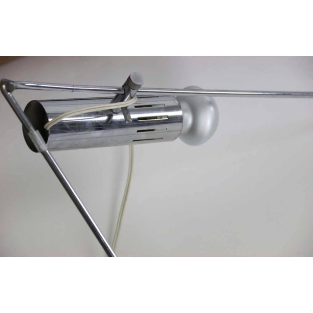 André Stern (20th century) Bookcase made of chromed steel rods, eight glass shelves. Integrated spotlights by Alain...