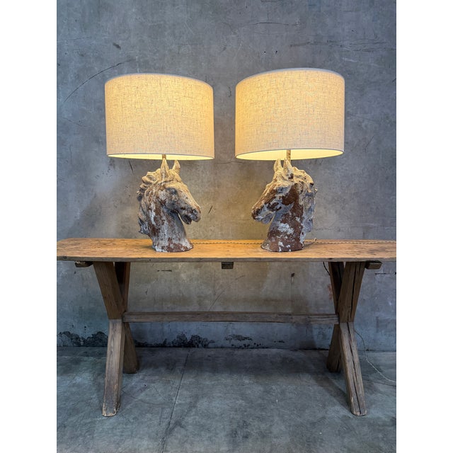 A commanding pair of cast metal horse head table lamps with genuine presence. Each base is a substantial sculpted horse...
