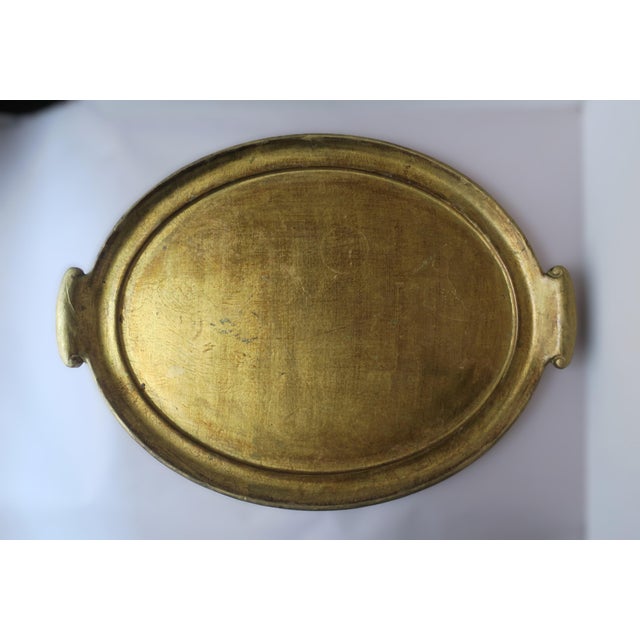 *Two available, each sold separately. An Italian oval gold giltwood serving tray with handles, circa late-20th century,...