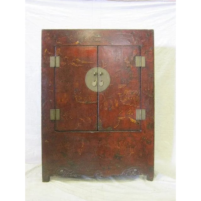 A spectacular 18th century large Chinese raised lacquer cabinet. This cabinet has a wonderful patina that only comes from...