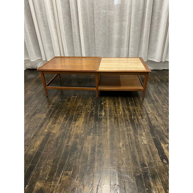 Beautiful large rectangular coffee table circa 1950s by Heritage. Walnut with a travertine inset at the top and partially...