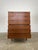 Elegant mid-century modern teak dresser featuring clean lines and beautifully integrated sculpted drawer pulls. The warm...