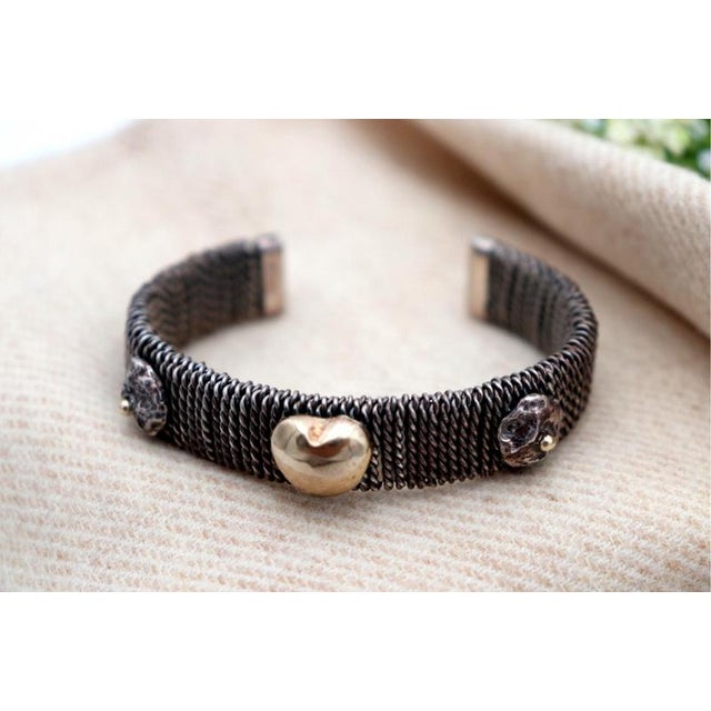 Gold Bracelet with a Heart-Shaped Paw Charm, in Worn conditions. Designed 1980 to 1989