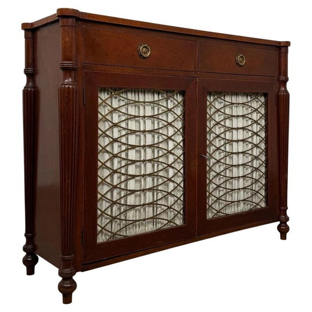 An elegant 19th century English Regency-style cupboard, finely constructed in mahogany and distinguished by its refined...