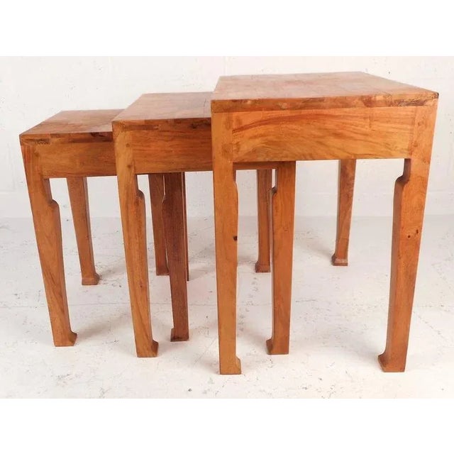 This set of three mid-century modern nesting tables feature sculpted legs and unique marquetry finish throughout. Wear...