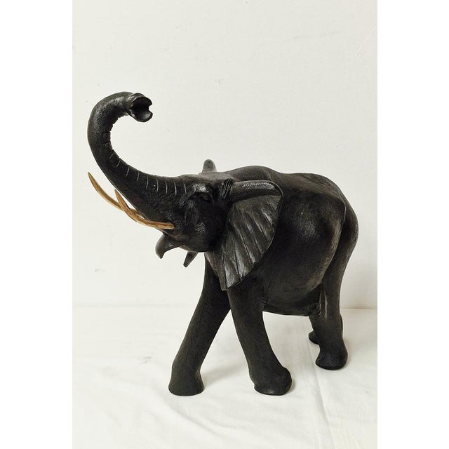 The raised trunk is often considered a symbol of good luck and protection.