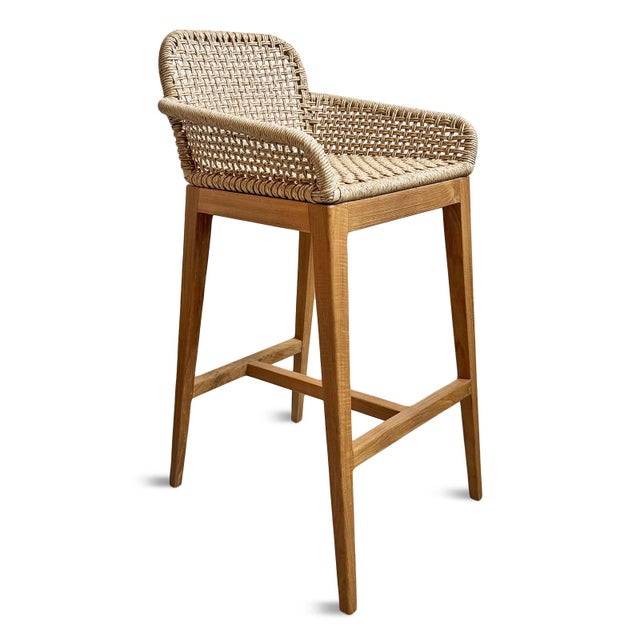 Premium teak and handwoven all-weather synthetic rope outdoor bar stool. This piece blends timeless craftsmanship with...