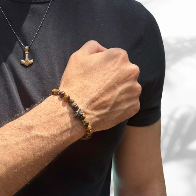 Unleash your inner power with the King Skull Tiger's Eye Stone Beaded Bracelet, a bold and striking accessory designed for...