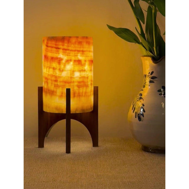 Comet pairs a hand-carved Egyptian alabaster shade with a geometric walnut base, combining contemporary form with...