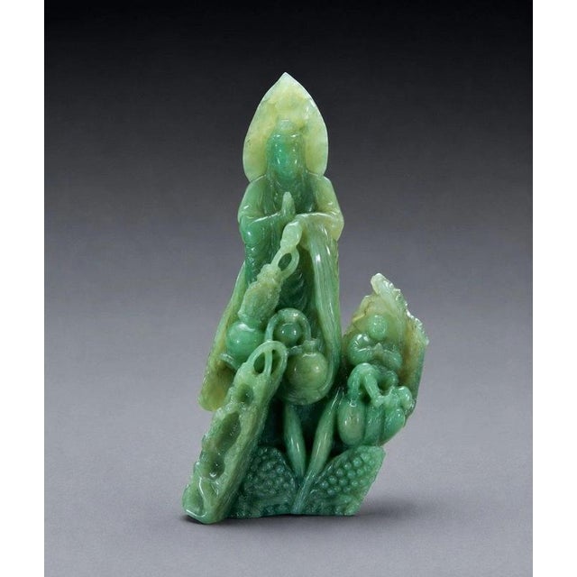 An impressive Chinese hand-carved jadeite sculpture depicting Guanyin, the revered bodhisattva of compassion and mercy,...