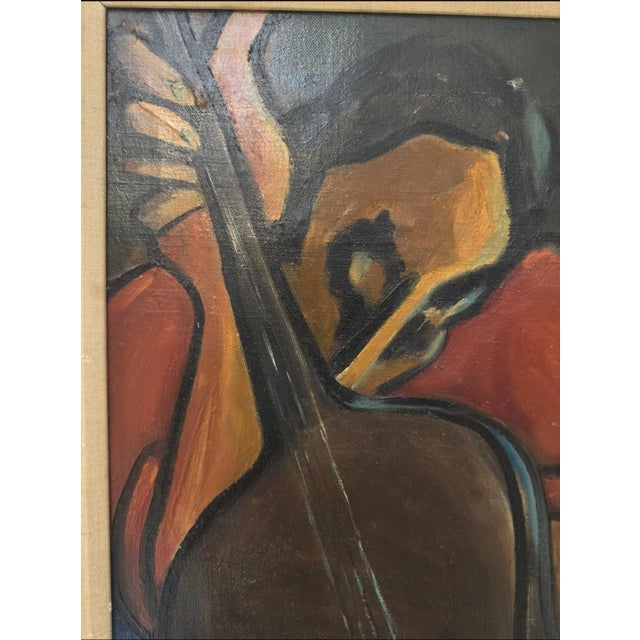 A Cubist-influenced oil painting depicting a figure playing a guitar, rendered in flattened, angular planes of red, blue,...