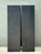 This striking pair of statuesque pedestals embodies the sleek, architectural minimalism of the late 20th-century Post-...