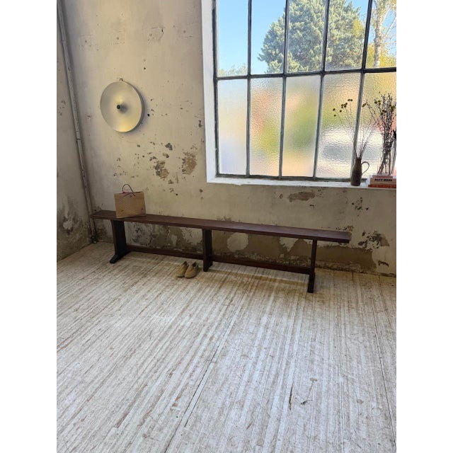 Dark solid oak bench from the early 1900s. Thick seat resting on a very elegant base with a central stretcher. The legs...