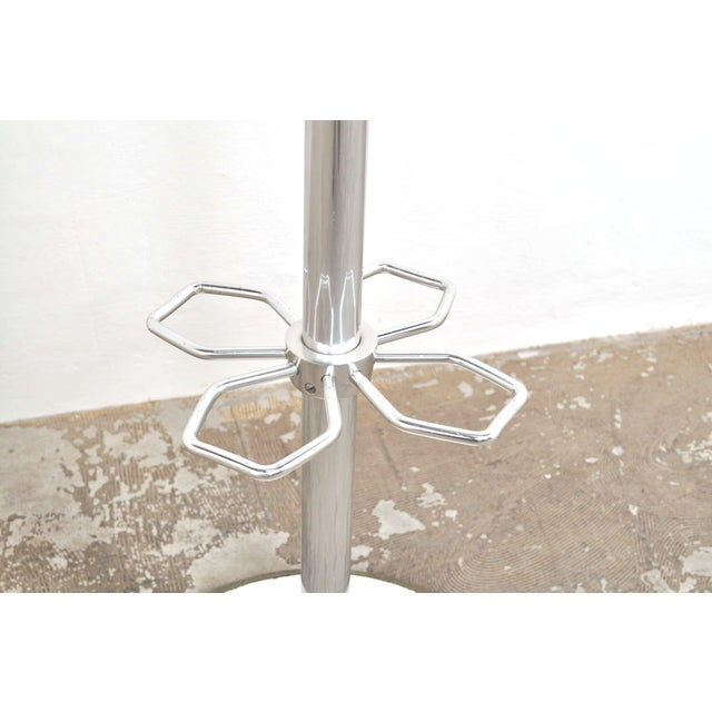 Very beautiful vintage coat rack from the 1950s. The freestanding coat rack features 9 hooks (triple) on the crown, four...